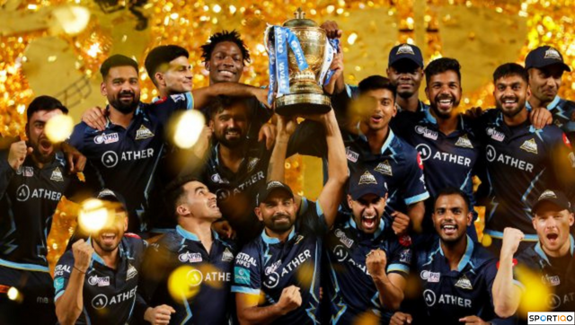 Gujarat Titans team posing with the trophy after winning the IPL in 2022.