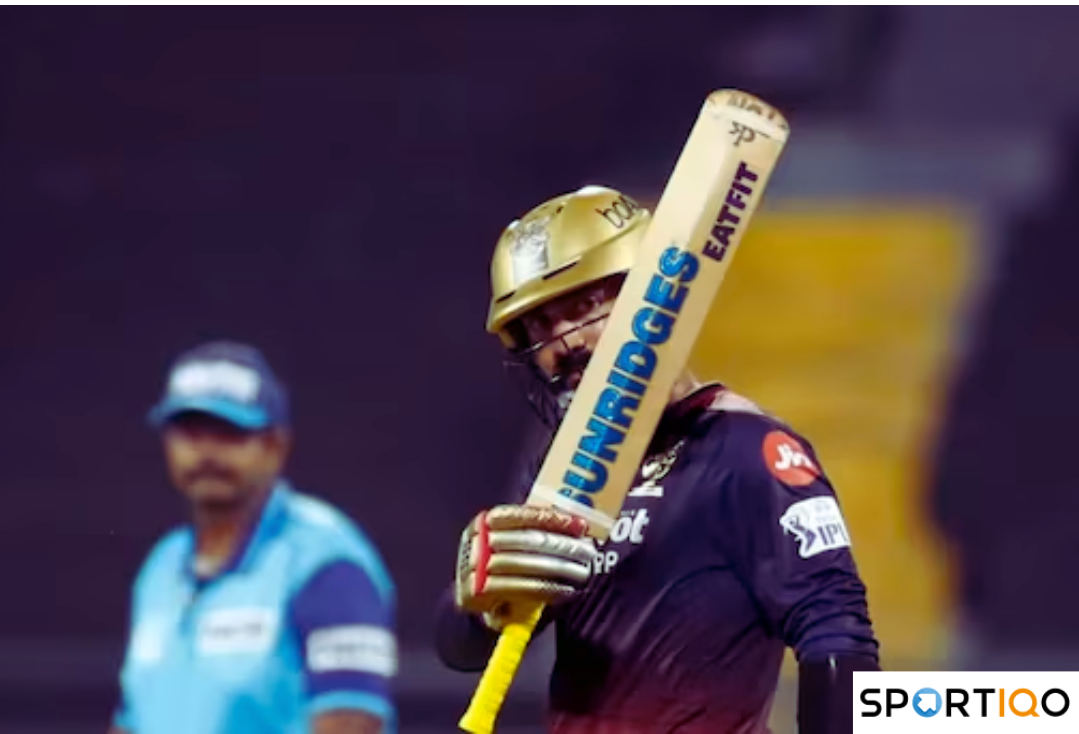 Dinesh Karthik raising his bat after scoring a fifty in IPL 2022.