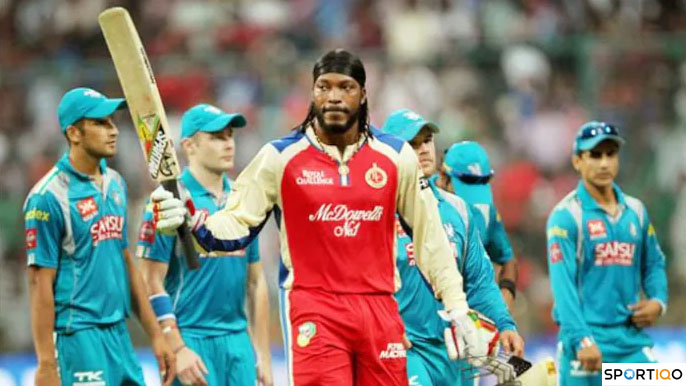 Gayle raising his bat after century.