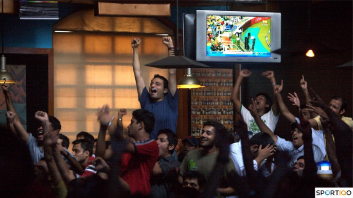 People enjoying an IPL match on TV