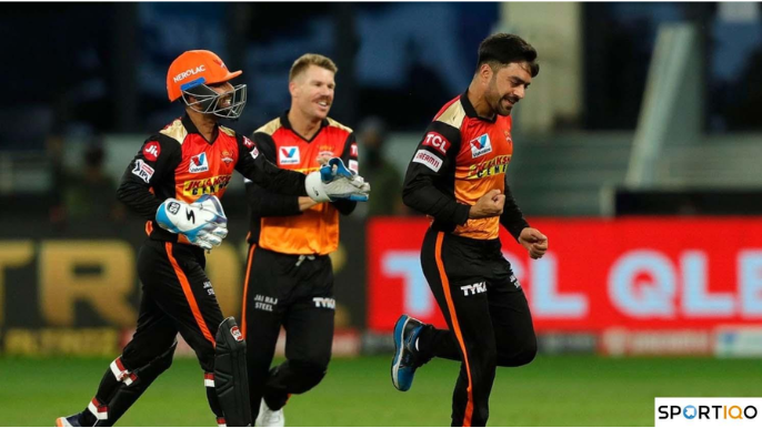 Rashid Khan doing a fist pump and celebrating with his other teammates while playing for SRH against DC in 2020